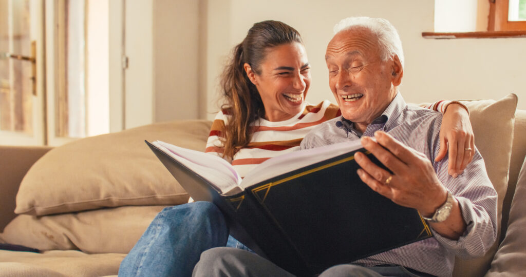 Father and daughter looking at a photo album together in warm light