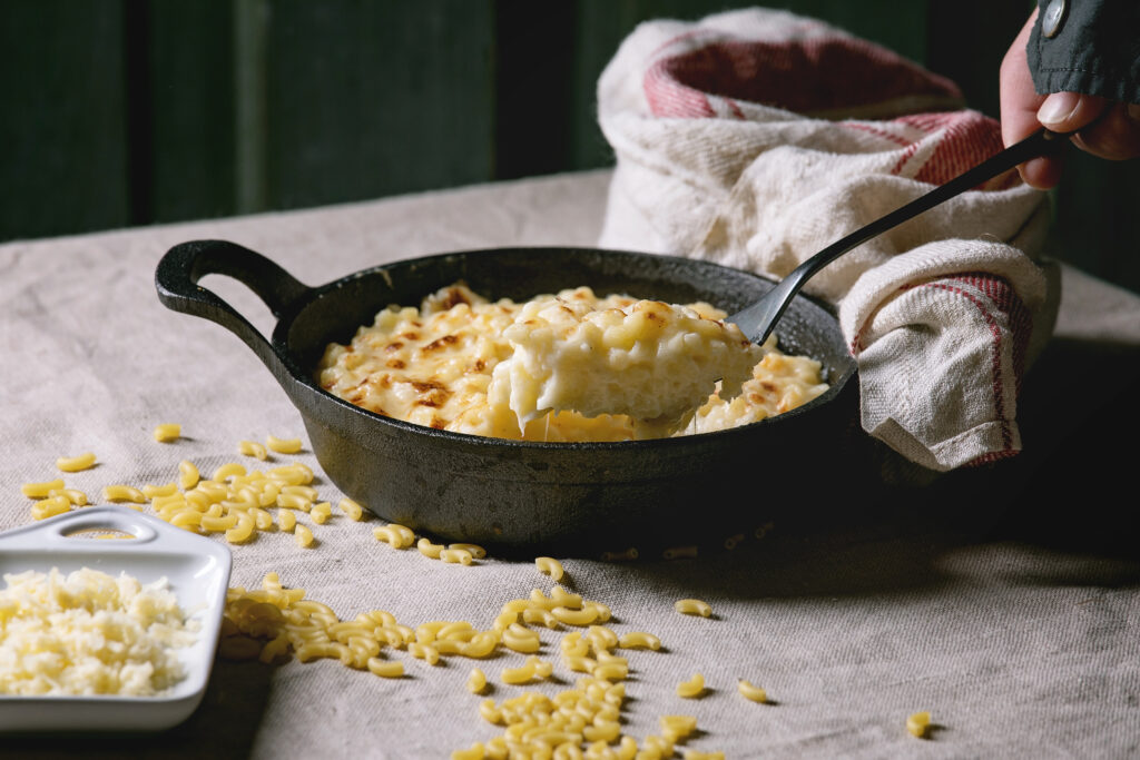 Man cooking with cast iron skillet in warm kitchen